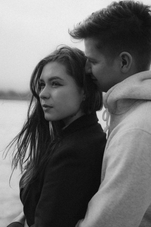 Free A loving couple embracing outdoors, capturing romance in a black and white scene. Stock Photo
