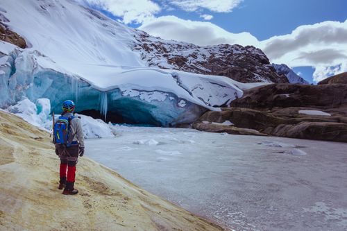 Free Captivating view of a lone adventurer exploring a frozen glacier in a mountainous landscape in Peru. Stock Photo