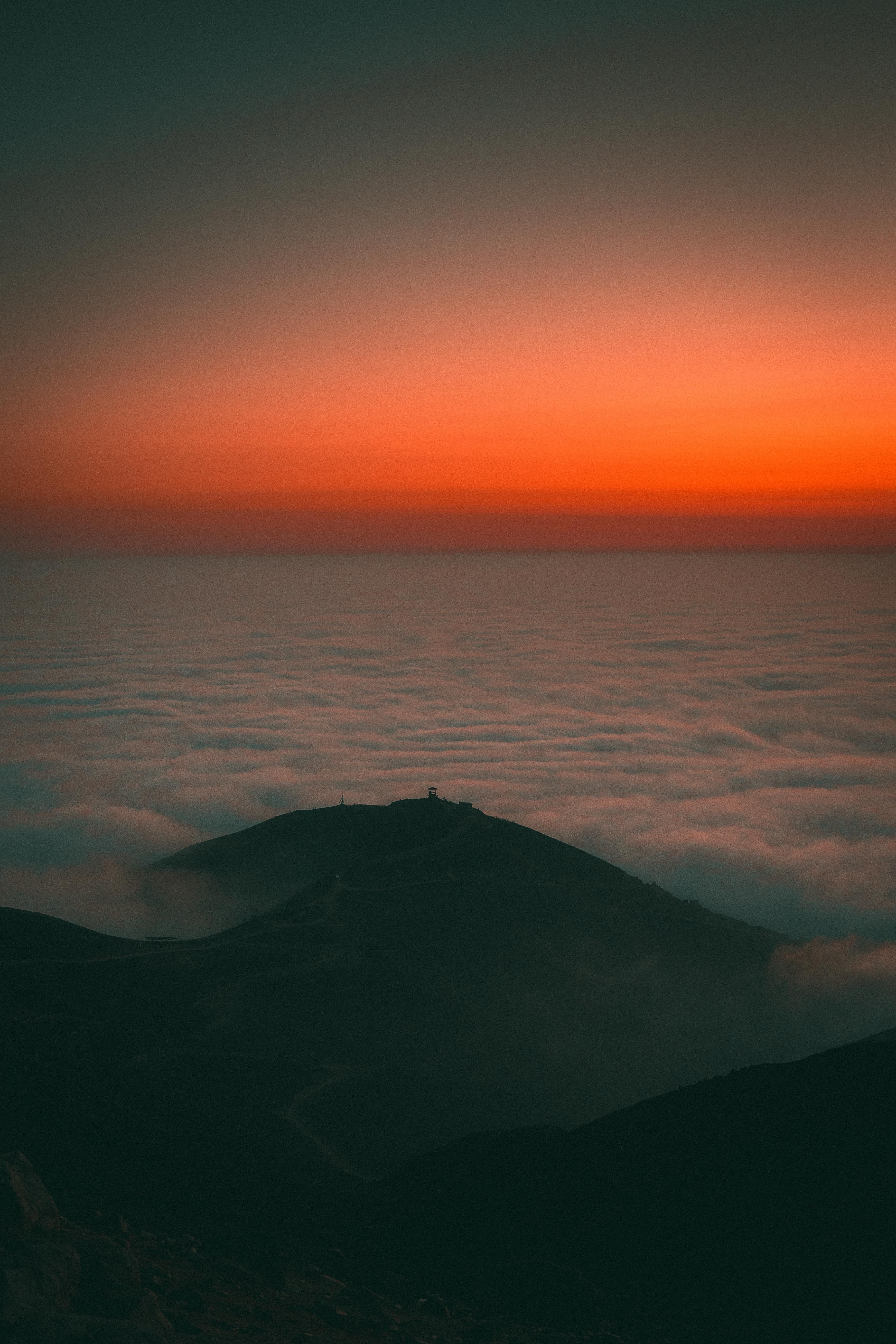 Clear Sky over Clouds over Hills at Sunset · Free Stock Photo