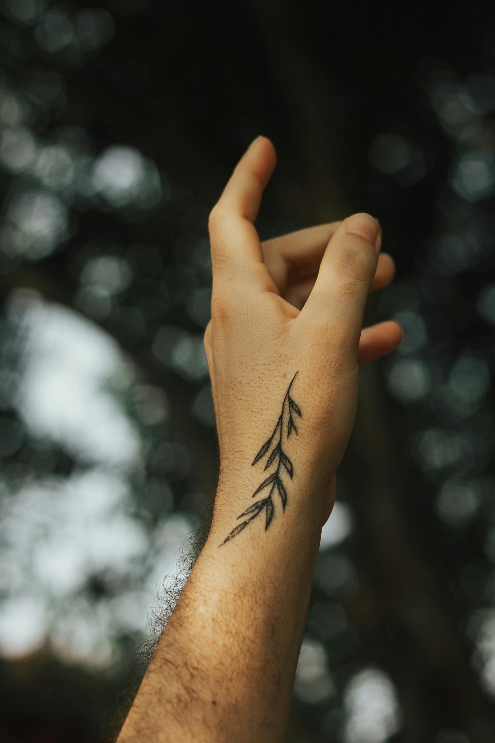 Leaf tattoo on the left inner arm.