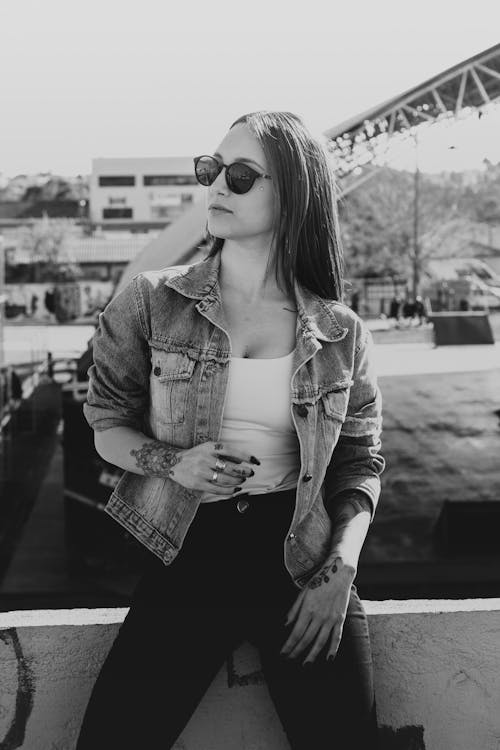 Woman in Sunglasses Posing in Jean Jacket in Black and White