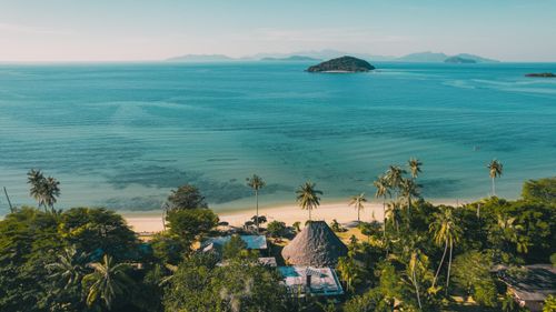Free Stunning aerial view of the tropical coastline on Ko Mak Island, Thailand, with lush greenery and azure waters. Stock Photo