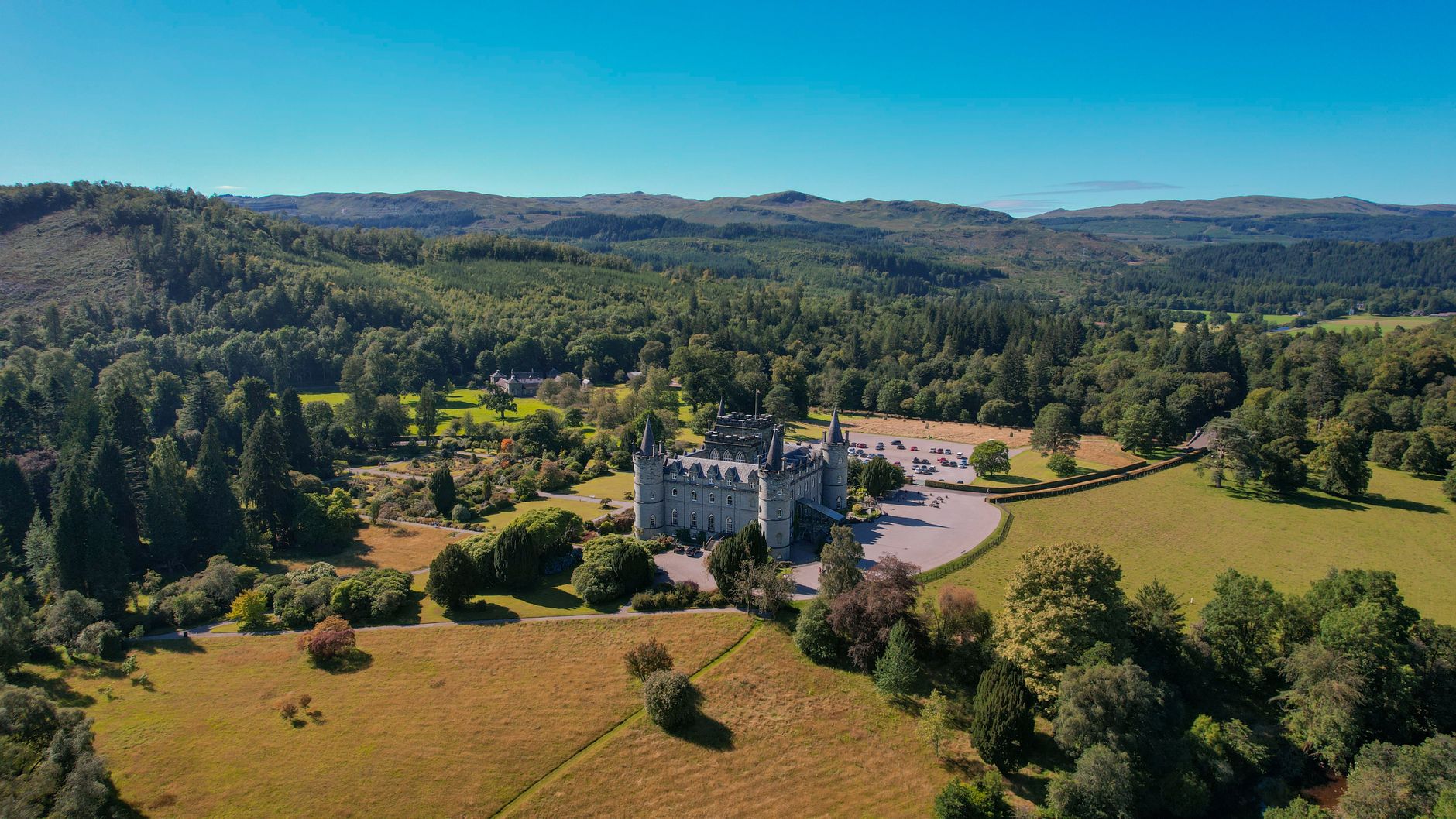 Aerial view of Inveraray Castle amidst lush Scottish landscape