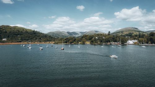 Free Beautiful aerial view of sailboats on the lake in Ambleside, England surrounded by lush hills. Stock Photo