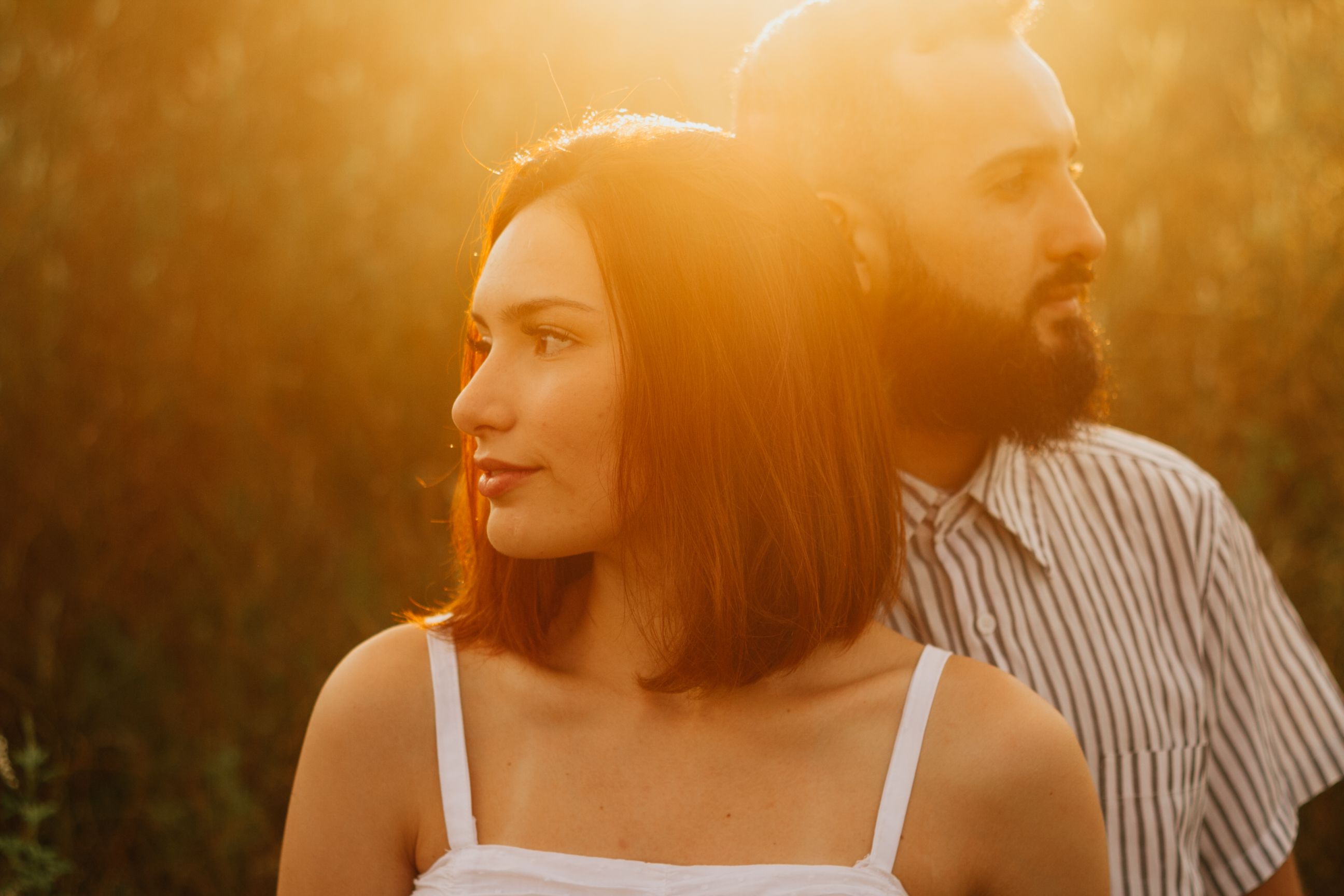 Couple sharing a romantic moment outdoors during golden hour