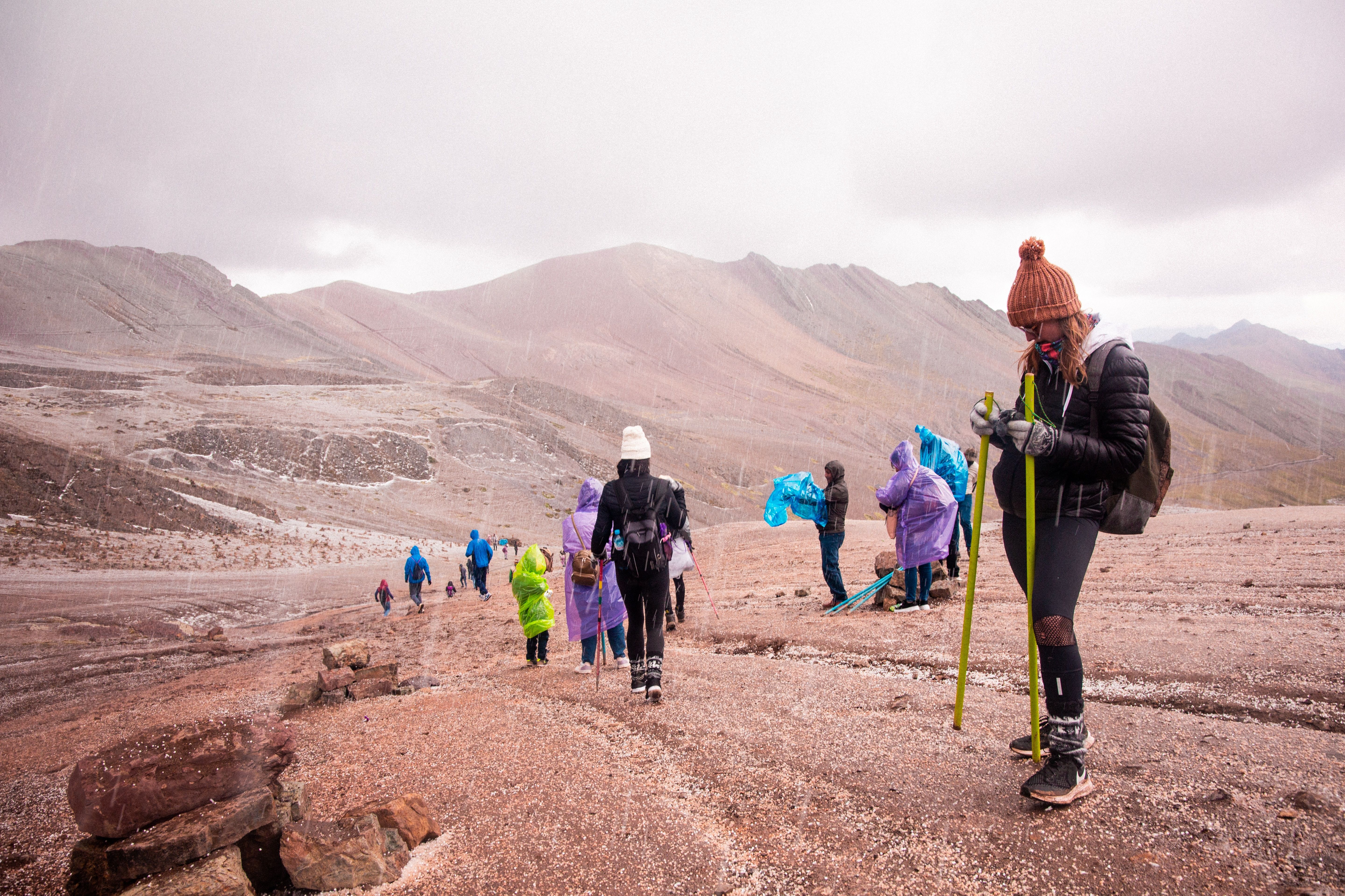 Traveler using a water purification filter to drink water in Peru's Sacred Valley