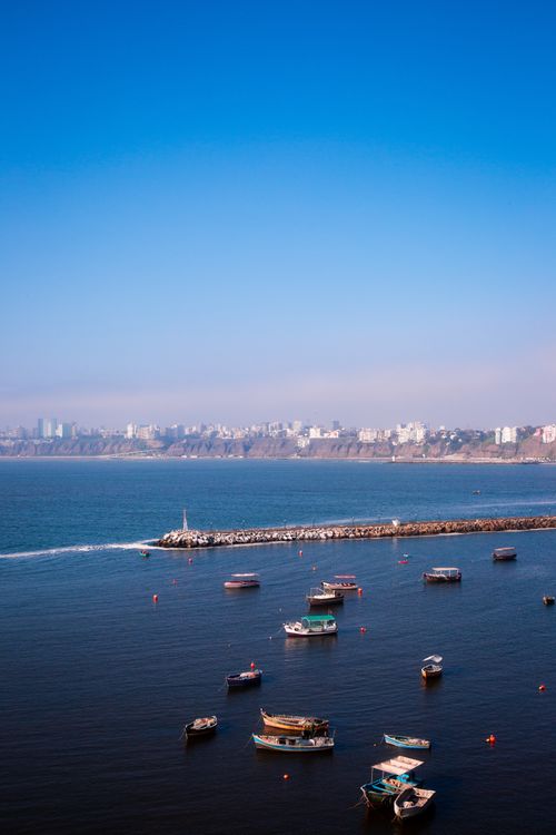 Free Aerial view of boats in Callao Harbor against a clear blue sky in Lima, Perú. Stock Photo
