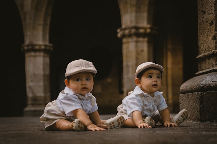 Babies Sitting On Pavement