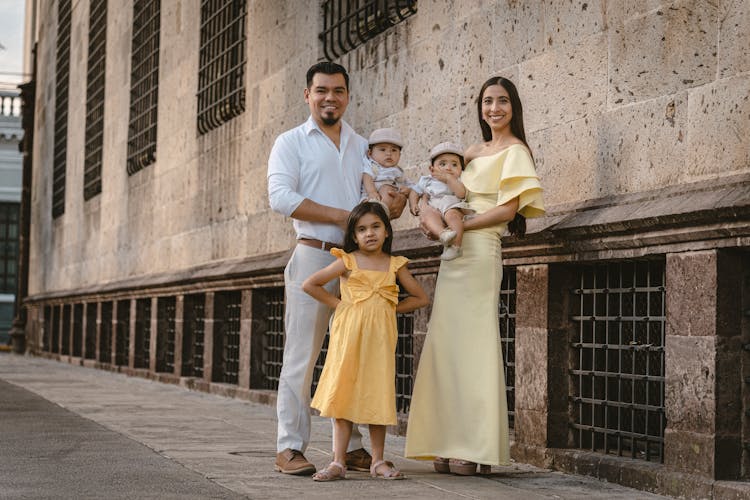 Mother And Father Smiling And Posing With Children