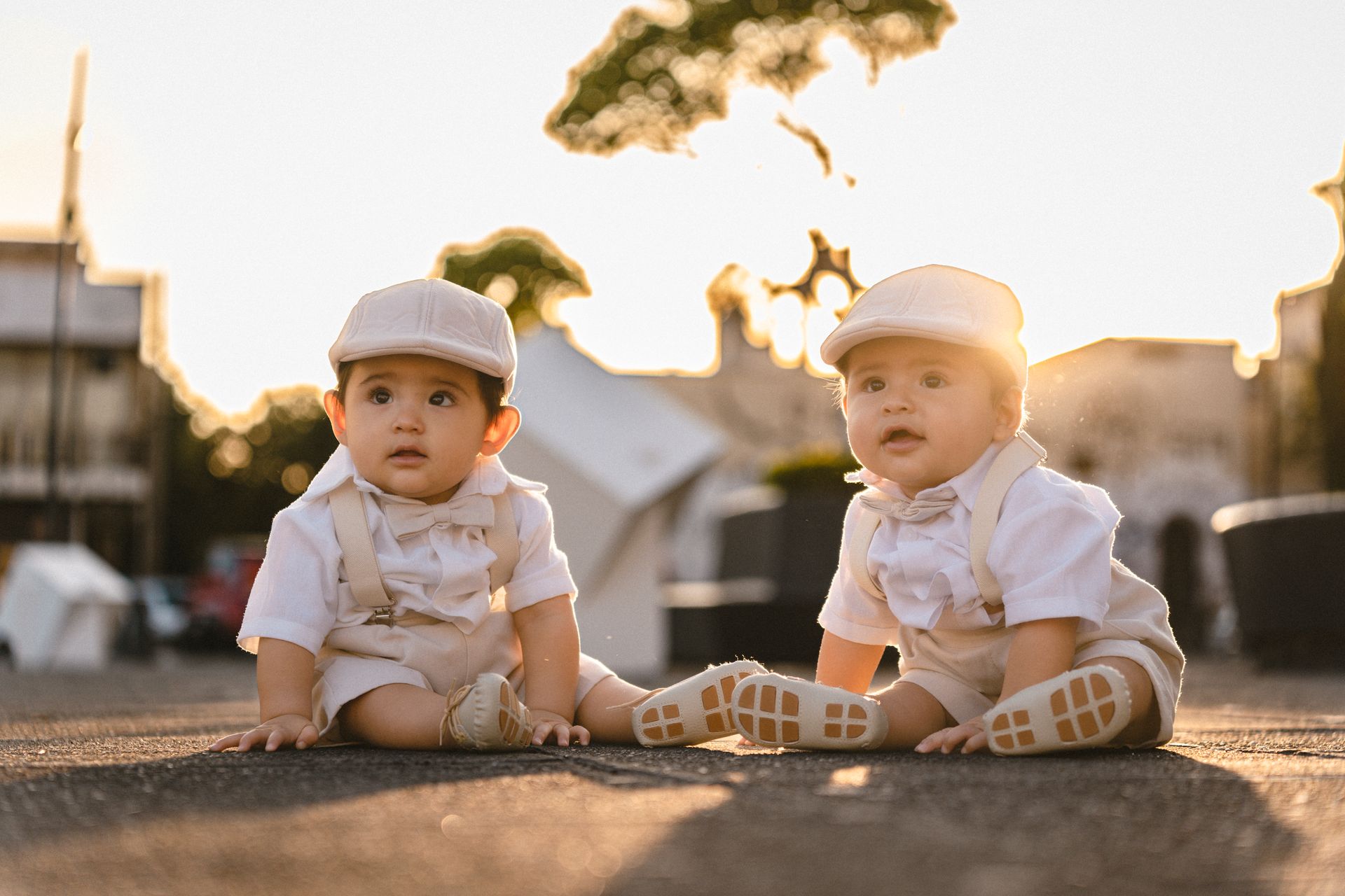 Baby Twins in Matching Outfits Sitting on the Ground