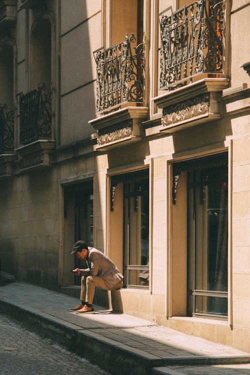 Man Sitting on the Urban Street