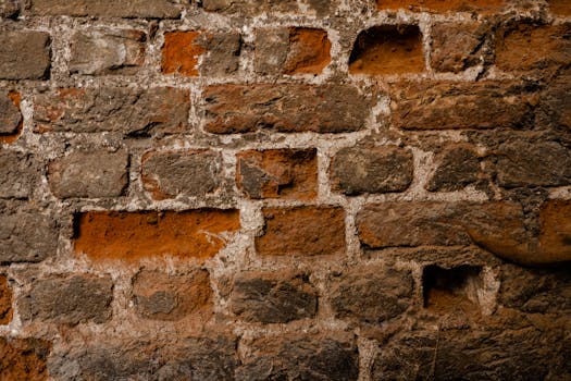 Close-up of a rustic brick wall showcasing rough textures and urban decay.