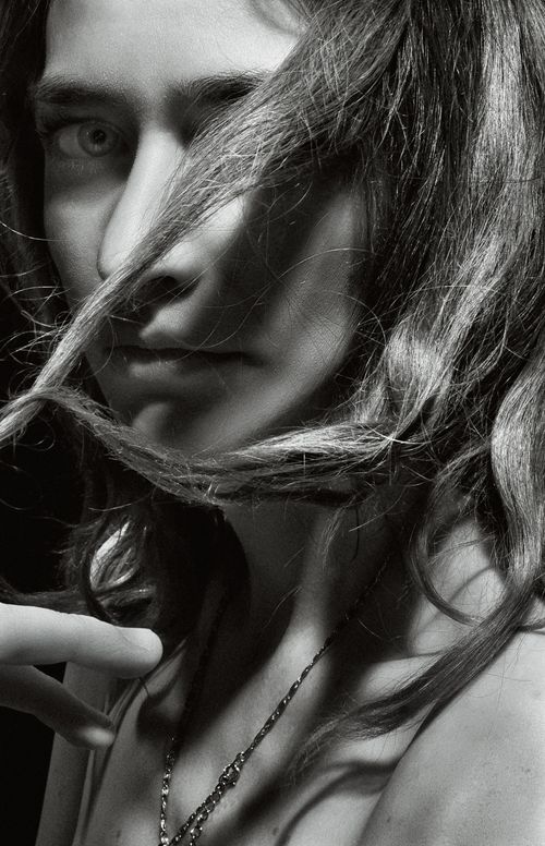Free Artistic black and white model portrait showcasing dramatic shadows and expressions. Stock Photo
