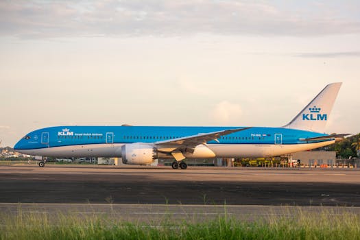 KLM airplane parked on tarmac during sunset, showcasing aviation and travel.