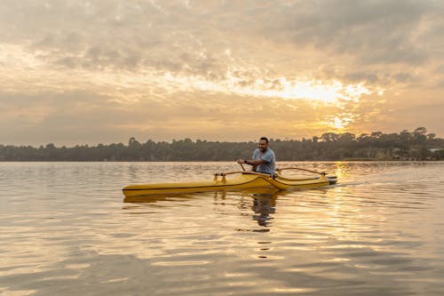 Man Kayaking at Sunrise