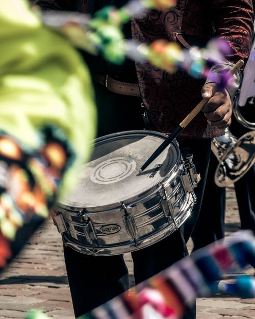 Free Close-up of a drummer playing in a lively outdoor festival parade. Stock Photo