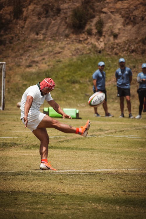 Man Kicking Rugby Ball