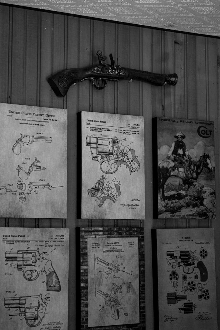 Vintage Gun On Wall Over Drawings Of Revolvers Mechanisms