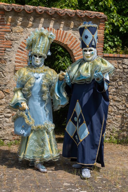 Free Two adults in ornate carnival costumes posing outdoors in Clisson, France. Stock Photo