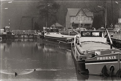 Motorboats Moored on River in Town