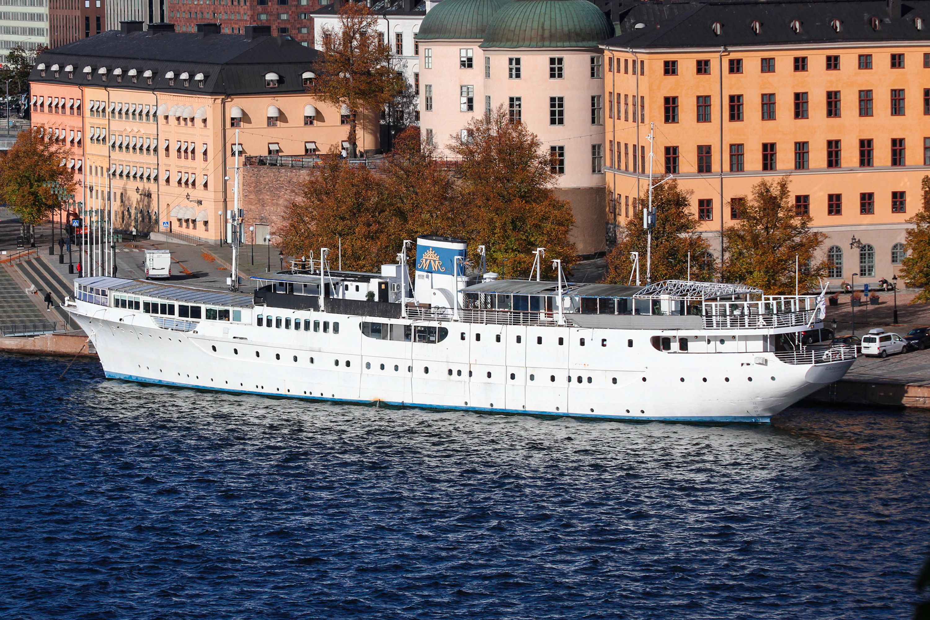 A stunning view of a moored ship hotel in Stockholm, Sweden, with urban architecture in the background.