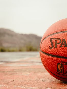 Detailed close-up of a basketball on an outdoor court in Akungba, Nigeria.