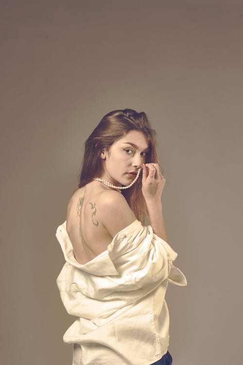 Studio Shot of a Young Woman Looking over Her Shoulder 