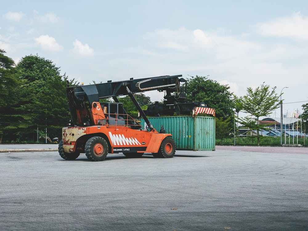 A Container Handler next to a Container · Free Stock Photo