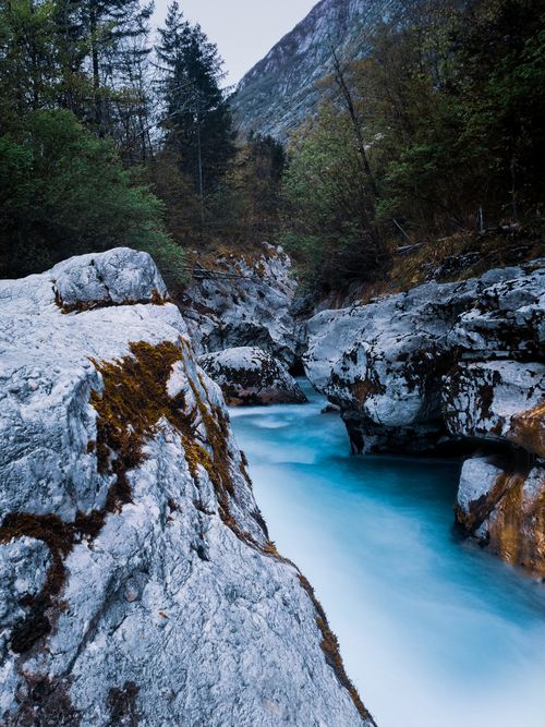 Free Explore the stunning blue waters and rocky terrain of Soča River in Slovenia's Tolmin Gorge, surrounded by lush forests. Stock Photo