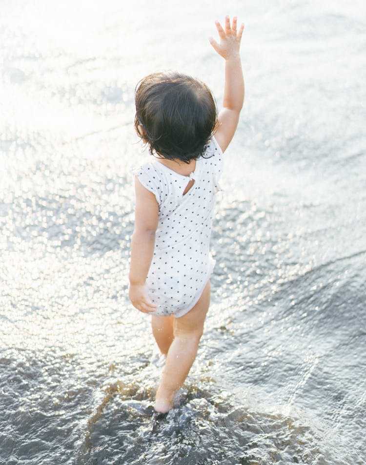 Child Walking In Water