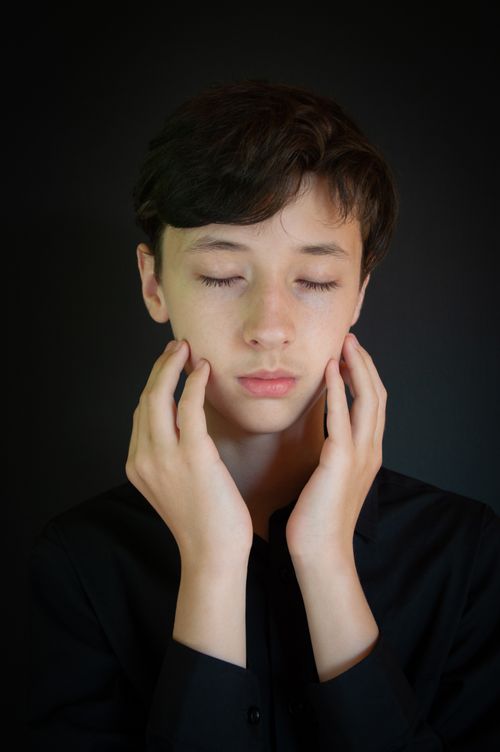 Free A serene portrait of a young man with eyes closed, showcasing calm and introspection. Stock Photo