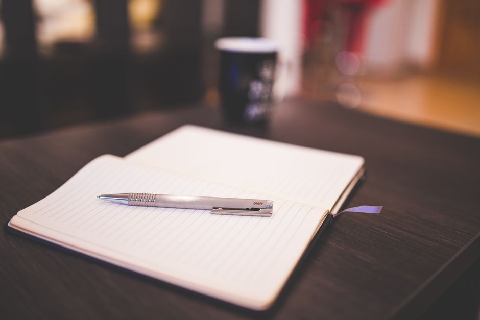notebook and pen on desk everyday scene lifestyle photo 1