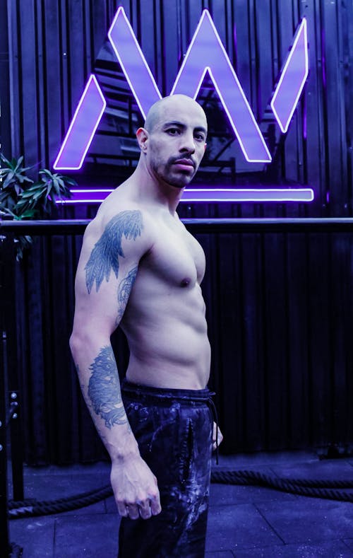Muscular Man Posing in Gym