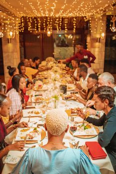 Family Sitting Together by Table
