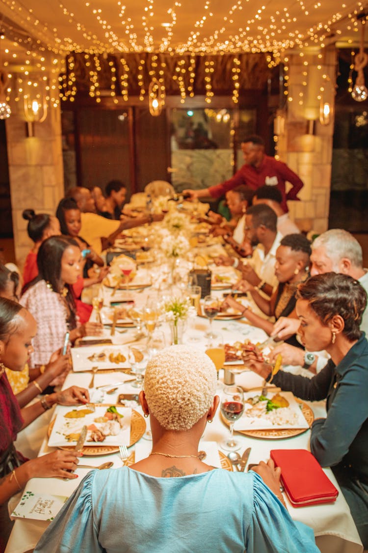 Family Sitting Together By Table