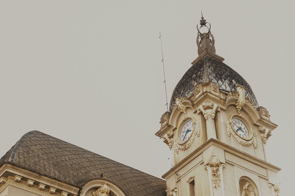 Close-up of an ornate neoclassical clock tower with intricate details and historical charm.