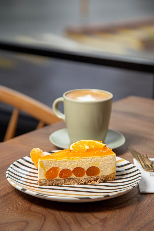 Free Orange Cheesecake and Cup of Cappuccino Stock Photo