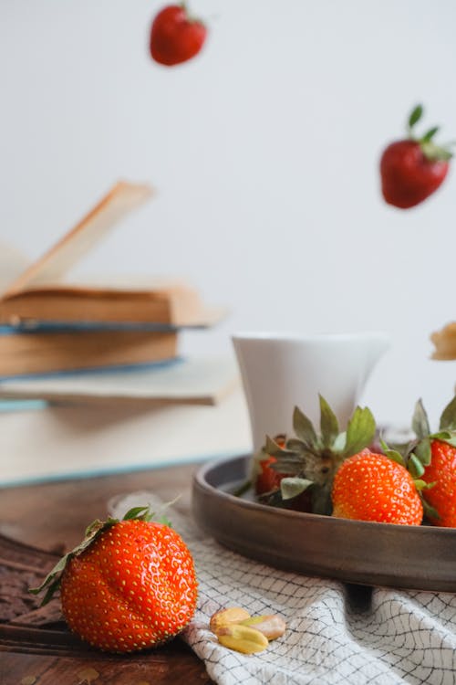 Strawberries on Plate and Flying around