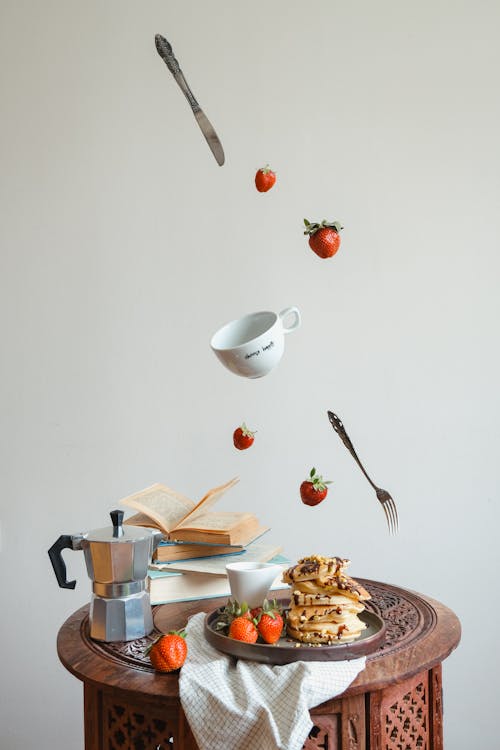 Free Cultlery, Cup and Strawberries Falling on Table with Breakfast Stock Photo