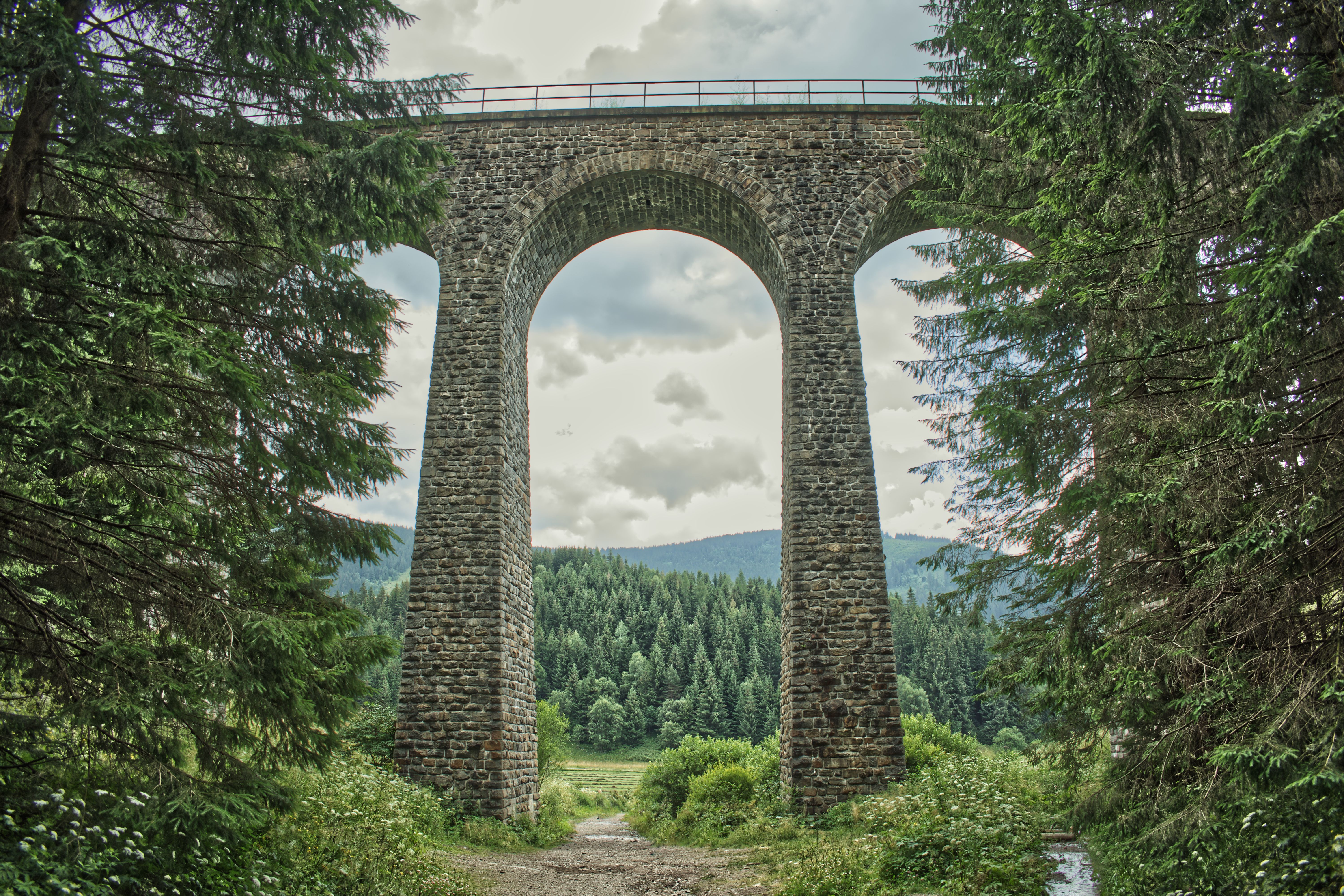 Majestic stone viaduct amidst lush forest landscape in Telgárt, Slovakia.