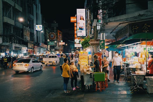 Lively urban night market with food stands and vibrant lights, showcasing city nightlife.