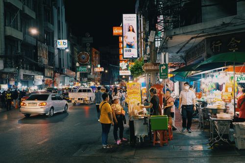 Free Lively urban night market with food stands and vibrant lights, showcasing city nightlife. Stock Photo