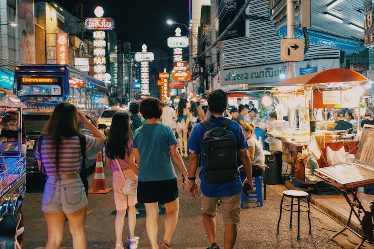 People Walking On Street At Night