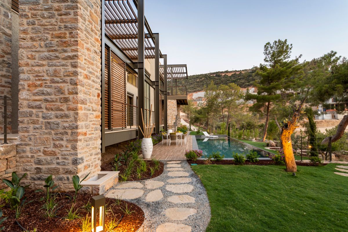 Berkeley Hills — villa stone facade with lush garden showing exterior limestone in full context