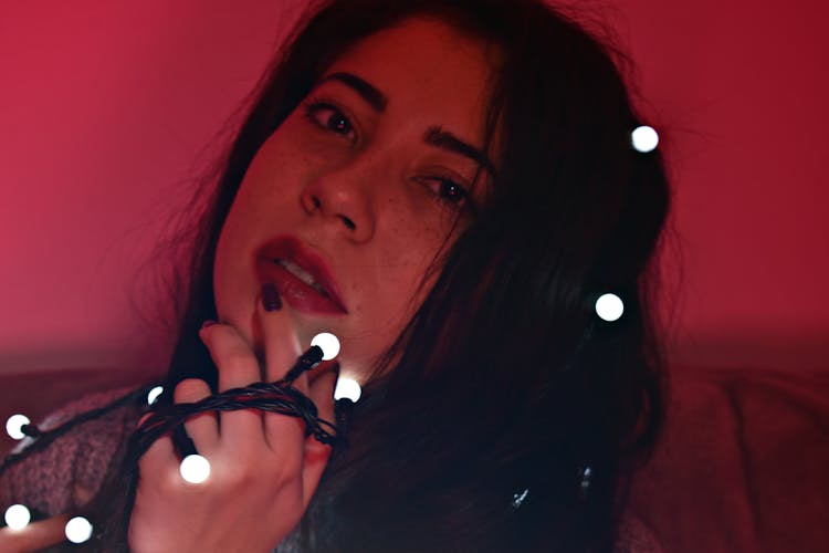 Close-Up Photo Of Woman Holding Fairy Lights