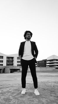 Black and white photo of a man posing outdoors in Erbil, Iraq.