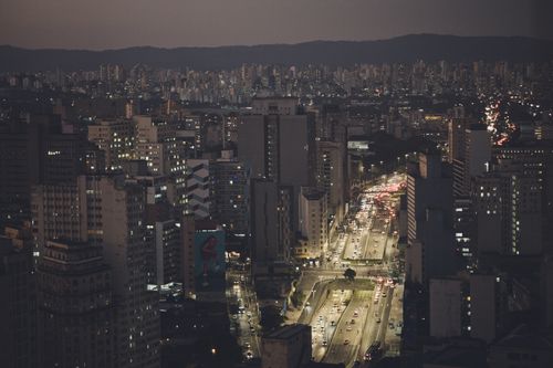 Free Aerial view of São Paulo's downtown with illuminated streets and skyscrapers at night. Stock Photo