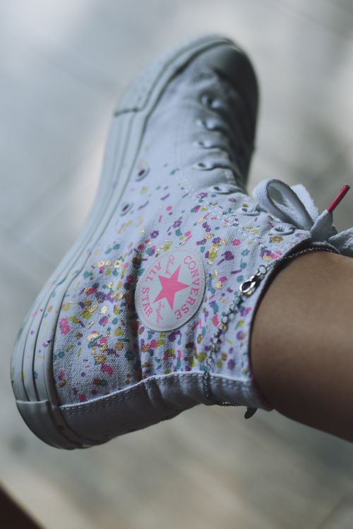 Free Trendy white sneakers featuring a floral pattern, perfect for casual fashion enthusiasts. Stock Photo
