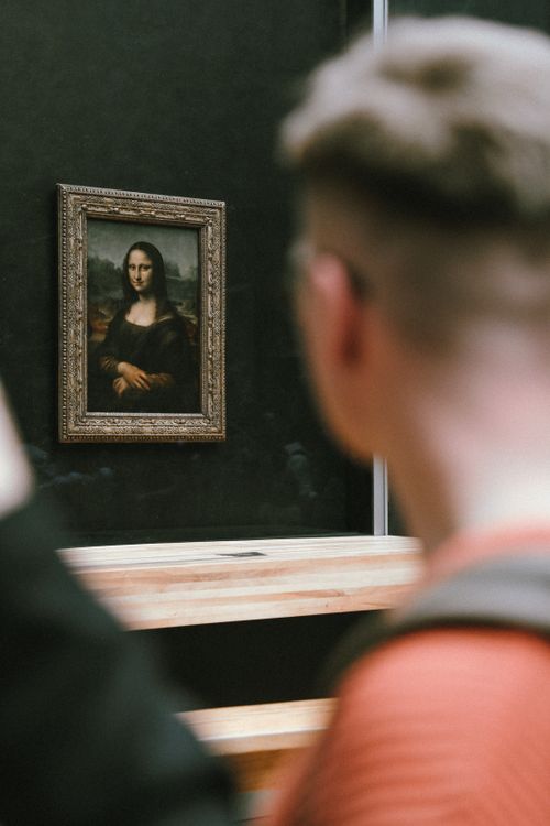 Free A visitor gazes at the iconic Mona Lisa at the Louvre Museum in Paris. Stock Photo