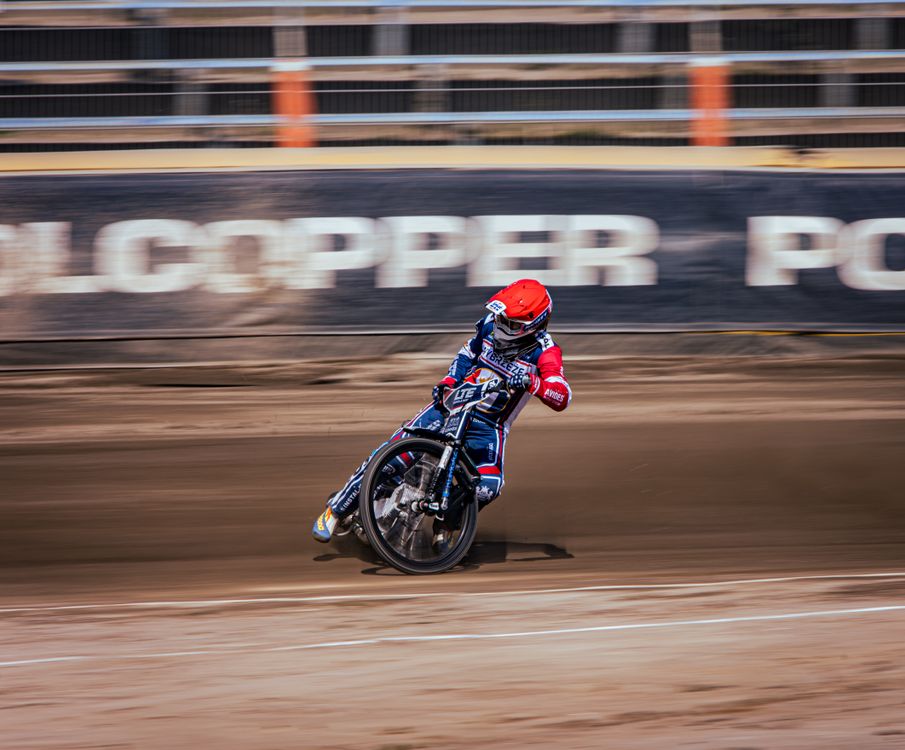 Motorcycle Racing Scene A dirt track with a motorcycle racing on it · Free Stock Photo
